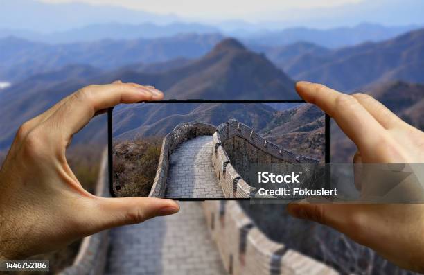 Tourist Taking A Picture With A Mobile Phone At The Great Wall In China Stock Photo - Download Image Now