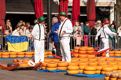 Alkmaar, Netherlands, March 25, 2022; At the traditional cheese market in the center of Alkmaar, the sales process of the large round yellow Dutch cheeses is watched with great interest.