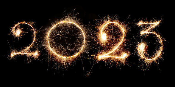 New Year 2023 made from sparkler on a black background.