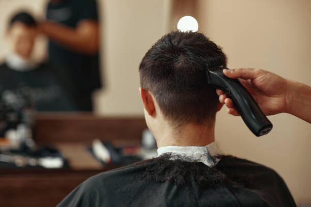 istock Barber shaving caucasian man in barber shop 1446754575