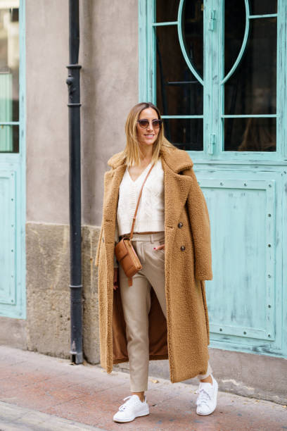 istock Stylish woman standing on street 1446754833