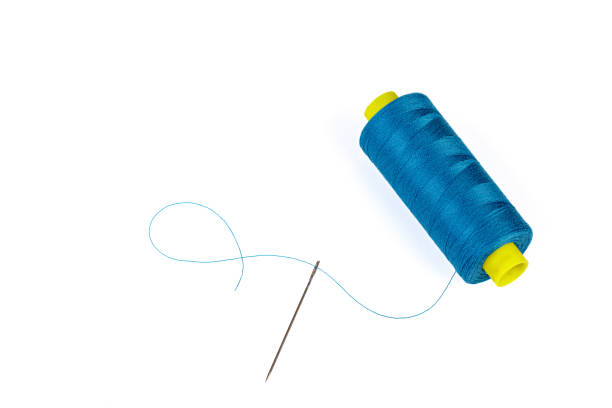 istock Macro skein of blue thread with a needle on a white background 1446755155