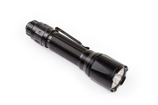 Modern tactical electric LED flashlight in black metal waterproof housing on a white background