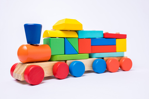 Front view of a wooden colorful train toy isolated on white background.