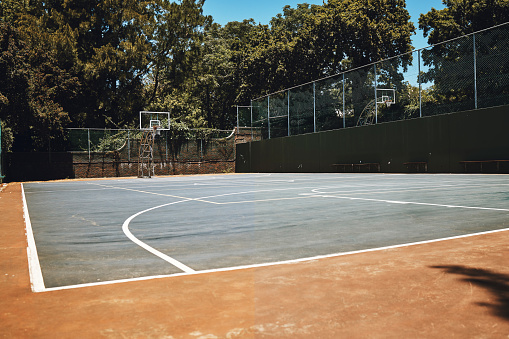 Sports, basketball court and nature, outdoor park and  space for youth to exercise, workout and play in summer. Basketball, fitness and health, playground with trees and motivation for playing game.
