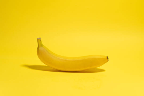 istock Whole banana on yellow background. Minimal fruit concept 1446761594