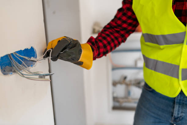 istock Electrician wearing protective gloves while working with wiring 1446763488