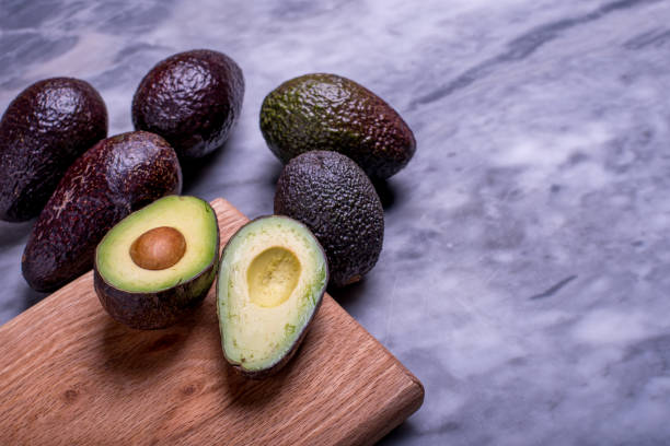 istock Fresh avocado on a marbel background. Top view. Free space for your text. 1446771738