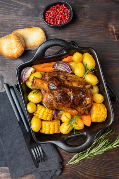 istock Pork meat shank with baked potatoes and corn 1446772700