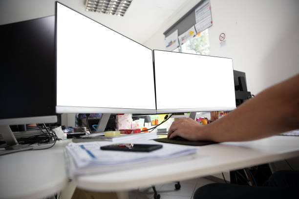 istock Two Screens in an office with white background. Mockup desk in the office. 1446774887