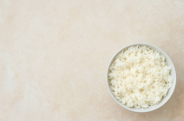 Cooked white rice in a bowl with japan sticks stock photo