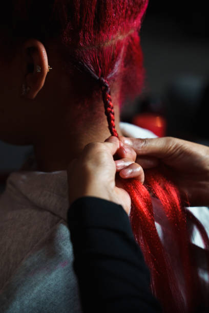 istock Stylist Braiding Hair in a Salon 1446779158