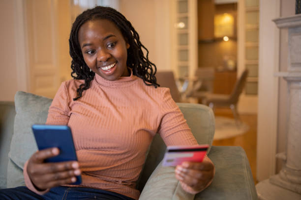 istock Cheerful  woman doing online shopping 1446781480