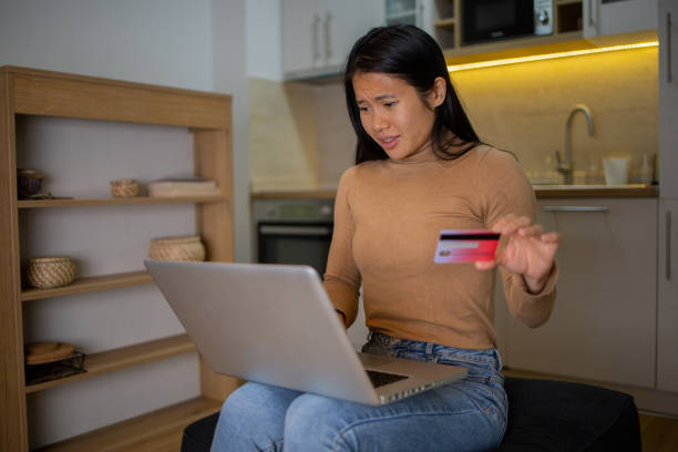 istock Cheerful  woman doing online shopping 1446781532