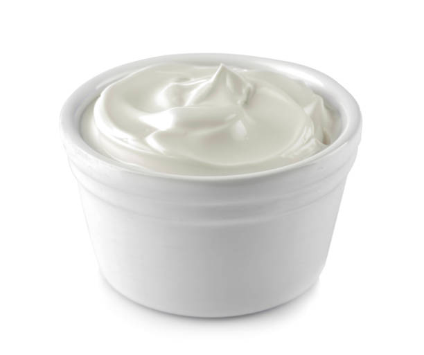 Mayonnaise in a white ceramic bowl on a white isolated background. white sauce. close-up