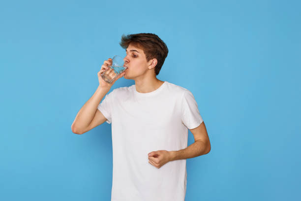 istock Young handsome man with drinking glass of water 1446783575