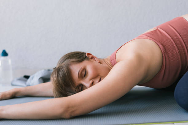 istock Woman Lying On The Mat, Relaxing After A Workout 1446786097