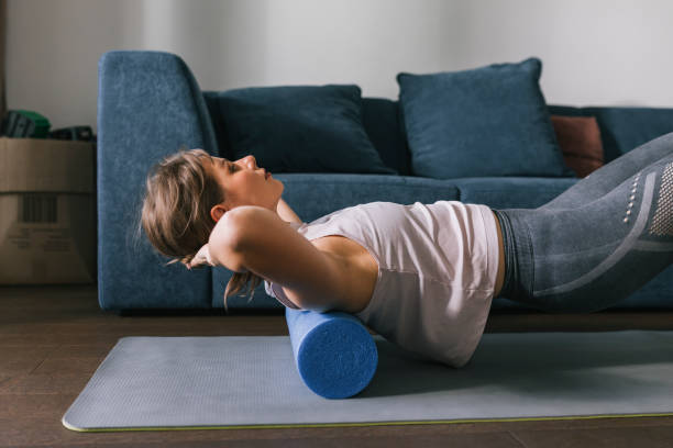 istock Brunette Relaxing Her Back On The Foam Roller 1446786198