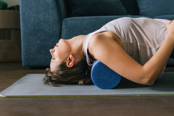 istock Brunette Relaxing Her Back On The Foam Roller 1446786200