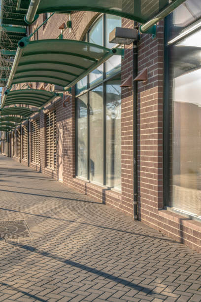 istock Footpath outside a building with bricks and wall-mounted green canopies- Phoenix, Arizona 1446790641