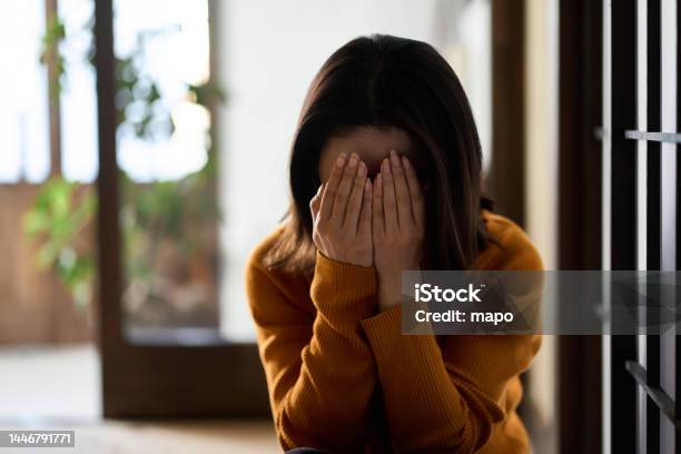 Woman Covering Her Face With Both Hands Stock Photo - Download Image Now - Women, Worried, Shame - Negative Emotion