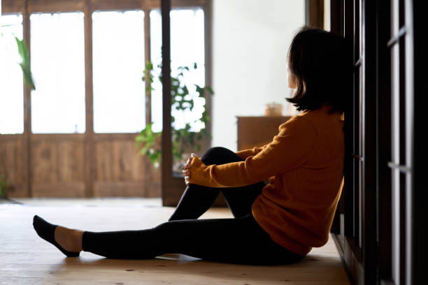istock A woman looking out with a dark feeling 1446791795