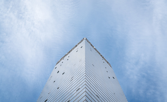 Modern office building in Kuala Lumpur. Low angle view, blue sky background. Copy space.
