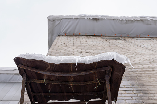 Snow covers an old table in winter, viewed from below. Khimki, Moscow region, Russia.