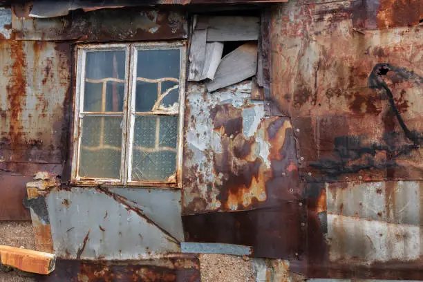 Photo of Broken window on wall of abandoned house