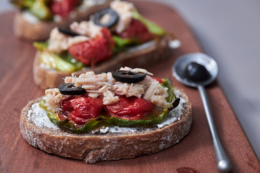 Delicious Brunch Toast, topped with tuna, tomato, chili pepper and olive