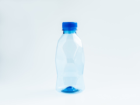 An empty geometry plastic water bottle with polygon shape, small size with blue cap cover and no label isolated on white background.