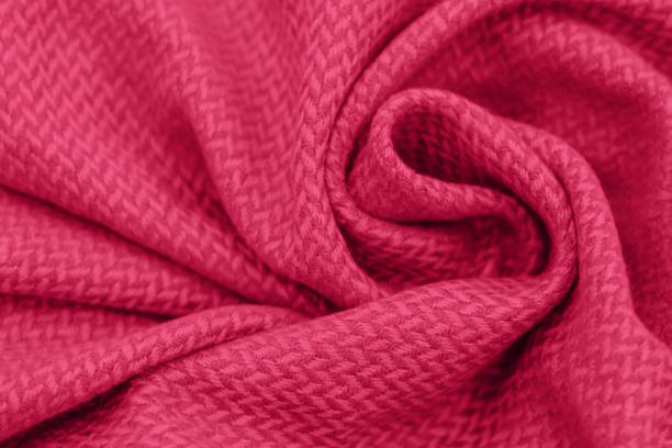 folds of knitted clothes close-up, concept color of the year 2023 viva magenta. - viva magenta stok fotoğraflar ve resimler