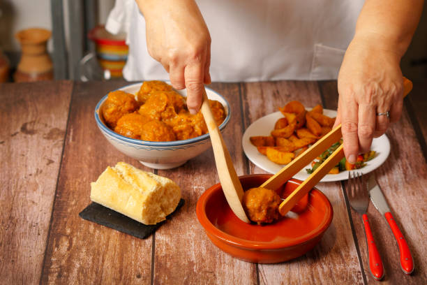 istock woman in white apron serving meatballs in an earthenware pot 1446820783