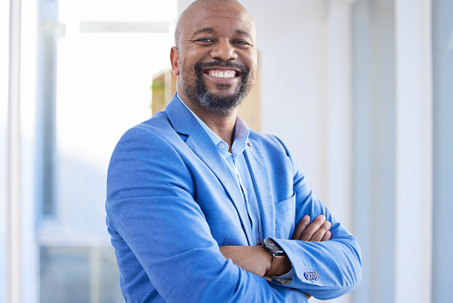 Happy, success and portrait of black man startup ceo, proud, confident and leader  African business. Vision, future and businessman in Africa with leadership in corporate company with smile in office