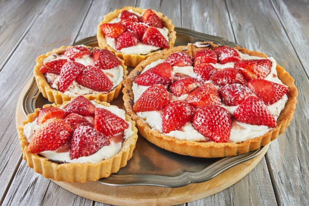 istock Round cream pie with strawberries. One big and three small 1446826977