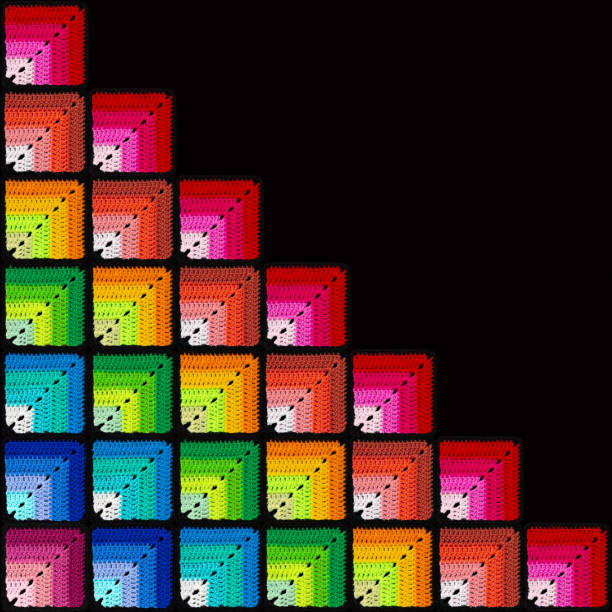 Bright background in the form of gradient squares is crocheted with colorful threads. Acrylic baby yarn. Rainbow blanket. Large knitted fabric.