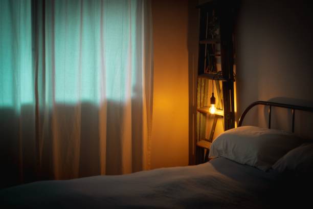 istock Bedroom interior with one light bulb next to the bed in the evening 1446829823