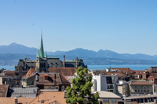 An aerial shot of historical buildings, Lake Geneva (Lac Leman) and the cathedral of Lausanne, Switzerland
