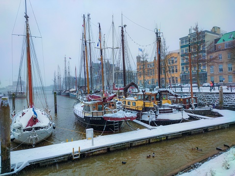 Rotterdam, Netherlands – January 04, 2022: A small harbor on a foggy winter day