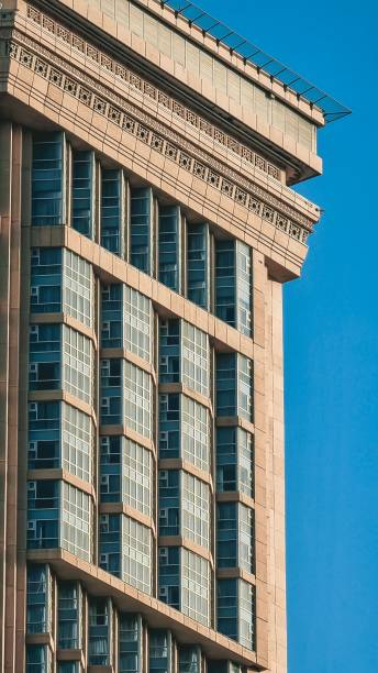 istock Facade shot of a modern skyscraper with pattern glass windows with blue sea 1446834536