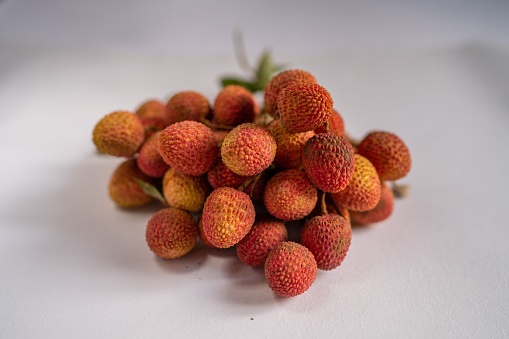 A closeup shot a bunch of litchi fruit isolated on the white background