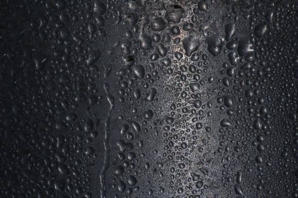 istock Black surface of wet drops texture background 1446838144
