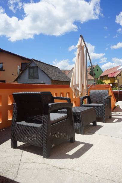 istock Vertical shot of chairs and table on a balcony under a sunny day 1446838792