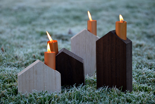 energy crisis of heating with fossil fuels such as coal gas. Schematic wooden houses are Advent decorations. they have copper metal chimneys from which candle flames whip, subsidies, energy savings, commodity, loss, recuperation, sweep, prices, gas lighting, houses, rental, decoration