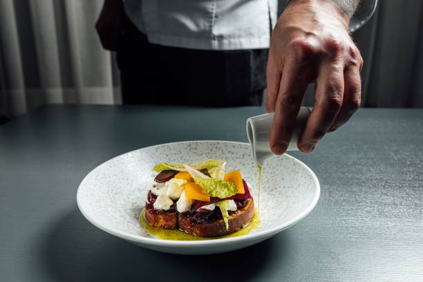 istock Chef pouring olive oil over Bruschetta with tomato and mozzarella cheese 1446839335