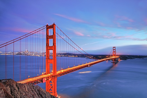 The illuminated Golden Gate Bridge in the evening in San Francisco, California, United States