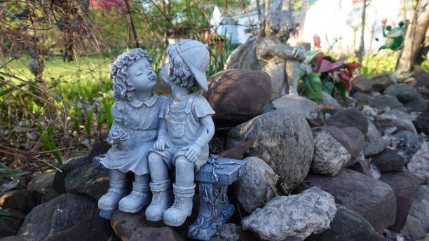 Small old angel figurine between plants and berries