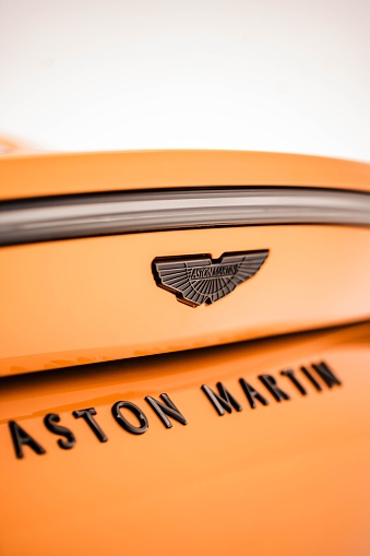Belo Horizonte, Brazil – November 01, 2022: A closeup of the Aston Martin Vantage Golden Saffron black piano rear badges