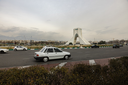 Azadi Tower or The Freedom Tower of Tehran, and Milad tower in the distance, with the Alborz mountain range even further back, Tehran, Iran