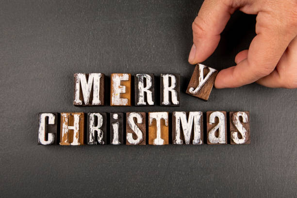 istock Merry Christmas concept. Greeting on a dark chalkboard background 1446841885